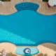 Aerial view of swimming pool outside hotel. Beautiful pool ready to holiday tourists.
